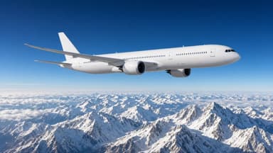 Passenger jet flying over snow-capped northern Pakistan mountains