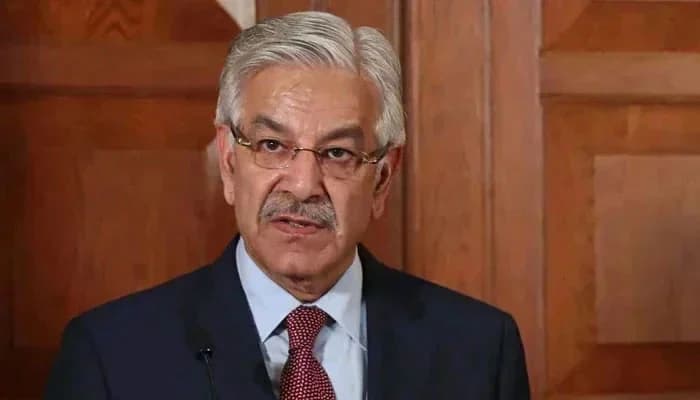 FILE – Defence Minister Khawaja Asif gestures during an event.