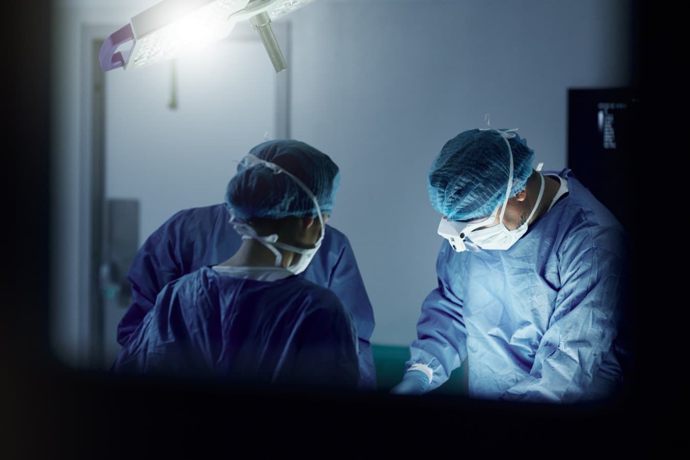Teamwork, emergency and doctors in a hospital for surgery together, working in theater to save a life. Medical, healthcare and a surgeon team in the operating room of a clinic for an operation; Shutterstock ID 2374428843; purchase_order…