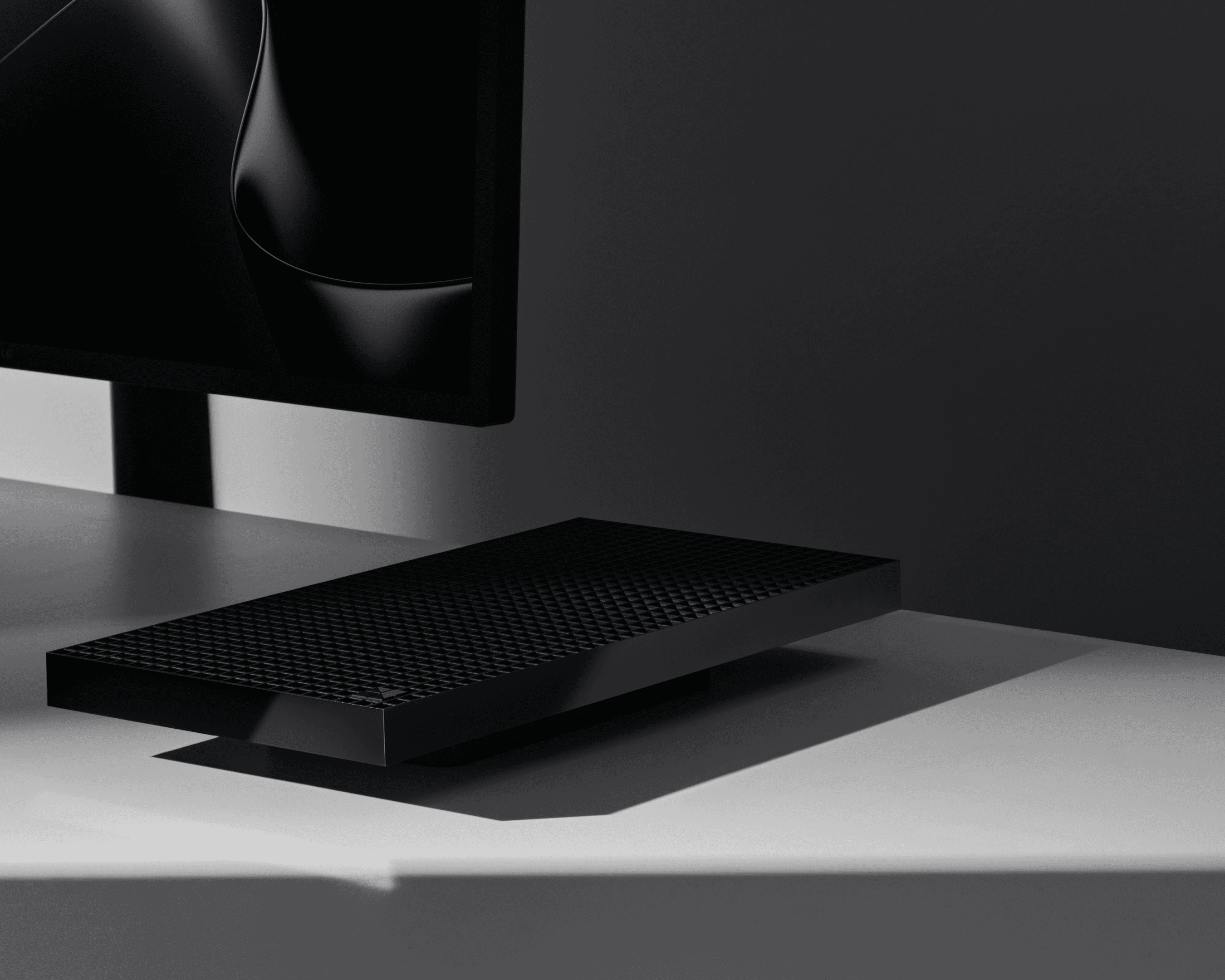 A Microsoft Surface RTX Spark Dev Box on a desk by a monitor