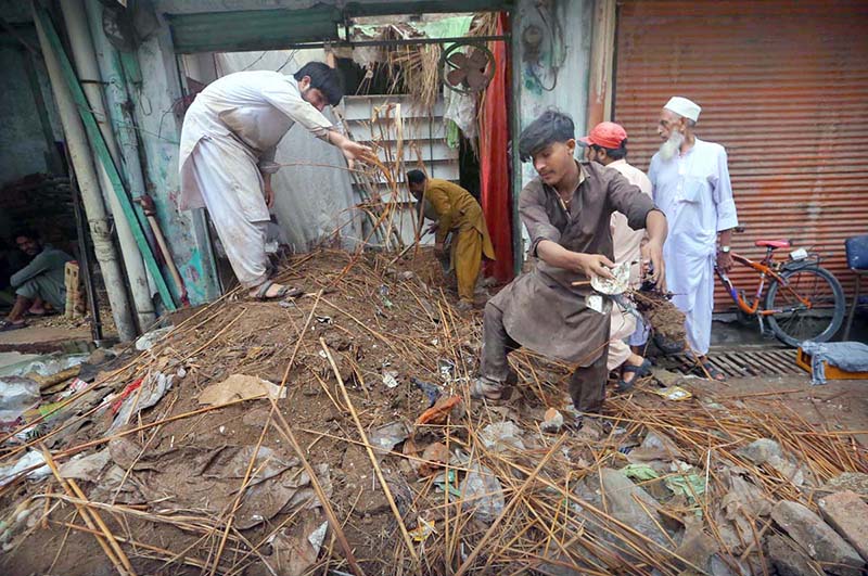 Residents clear debris after shop roof collapse in provincial capital