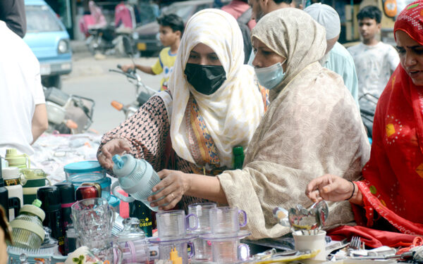 Women buy kitchen items from street vendors Women buy kitchen items from street vendors