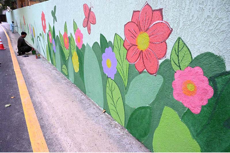 Artist paints wall in Muslim town during city beautification