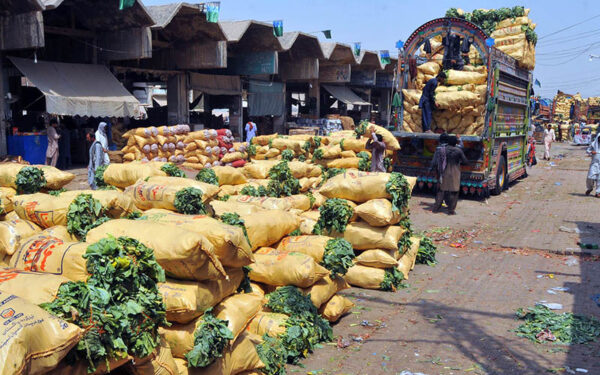Labourers Unload Fresh Vegetables at Busy Market Labourers Unload Fresh Vegetables at Busy Market
