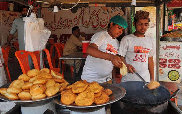 Young Vendors Serve Traditional Snacks at Roadside Stalls