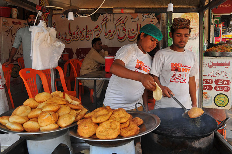 Young Vendors Serve Traditional Snacks at Roadside Stalls Young Vendors Serve Traditional Snacks at Roadside Stalls