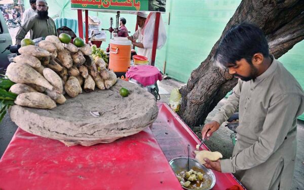 Street vendor serves coal-roasted sweet potatoes to eager customers Street vendor serves coal-roasted sweet potatoes to eager customers