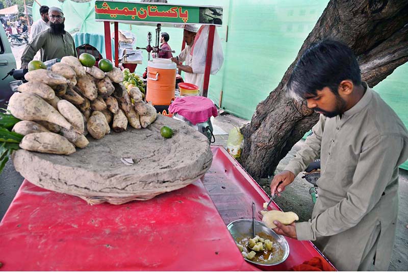 Street vendor serves coal-roasted sweet potatoes to eager customers Street vendor serves coal-roasted sweet potatoes to eager customers