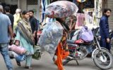 Woman carries cotton-filled quilts as weather turns cooler