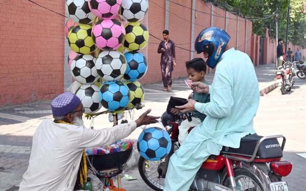Disabled vendor sells balls by roadside to support family