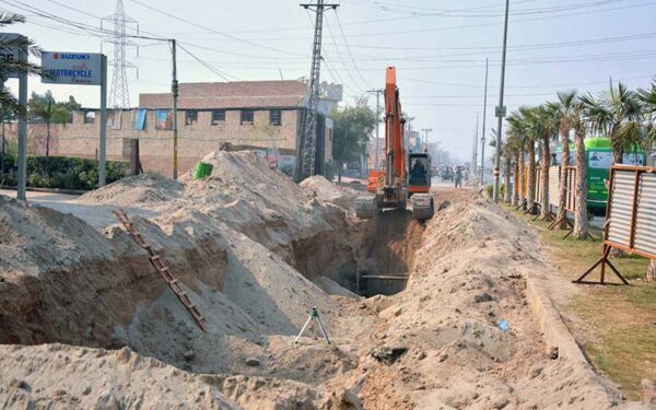 Labourers Lay Sewerage Pipeline Along LMO Road